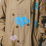 Vintage upcycling trench coat with raglan sleeves and cape with rhinestones and hand-painted illustration - size 50/52